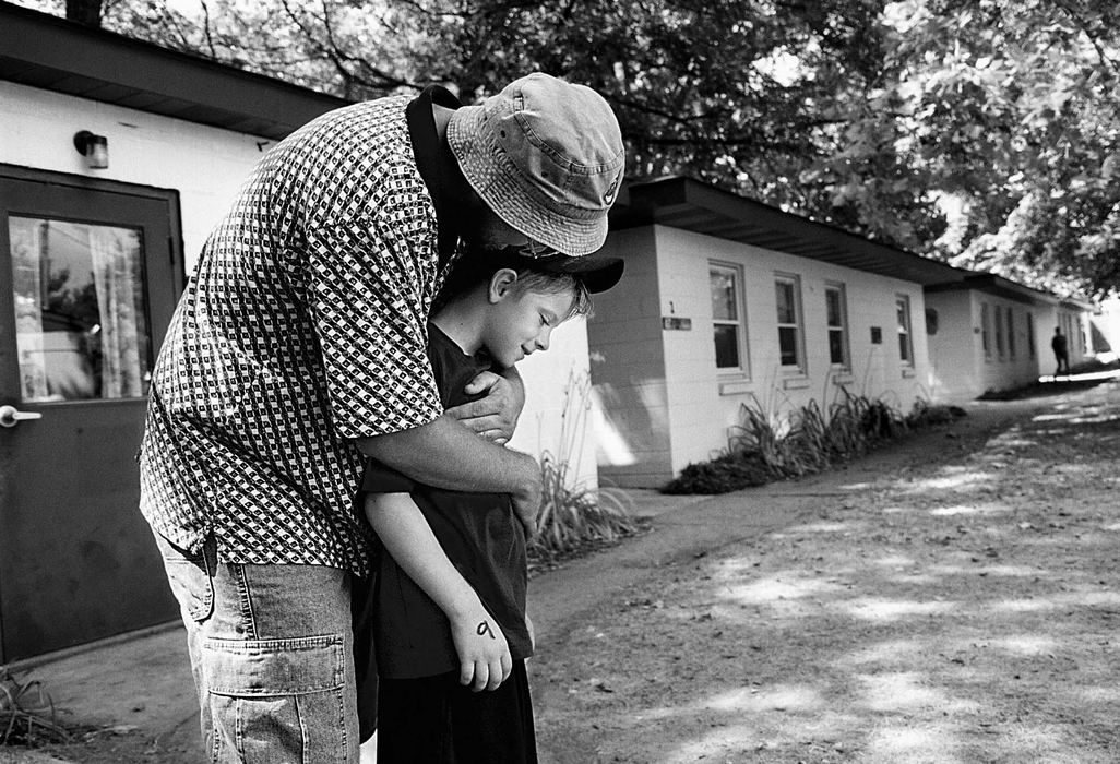 Second Place, Student Photographer of the Year - Greg Ruffing / Kent State UniversityBobby gets a goodbye hug from his father, Pat, as his parents prepare to leave him at the camp. This is Bobby's first time away from home for an extended period of time.