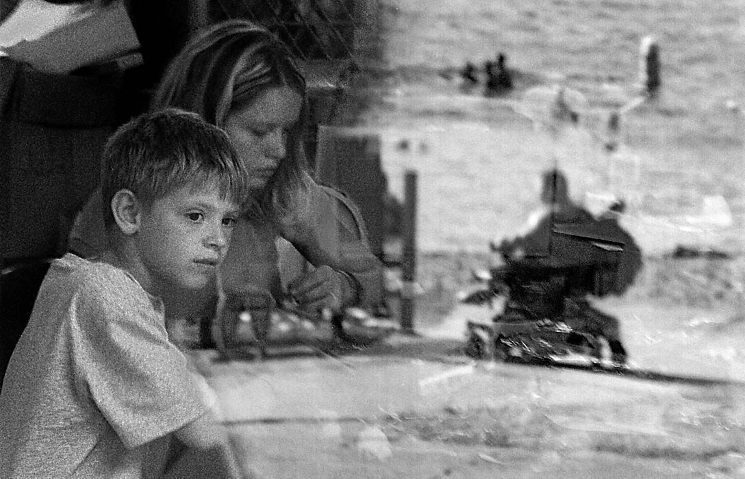 Second Place, Student Photographer of the Year - Greg Ruffing / Kent State UniversityBobby looks out the window at other campers going swimming in the lake while he and camp counselor Agnes Dyduch sit in the arts and crafts room. While many of the other kids had been attending the camp for years, this was Bobby's first year. At first he had a hard time making friends and consequently withdrew himself from some activities.