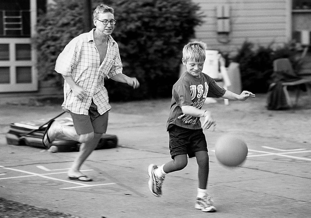 Second Place, Student Photographer of the Year - Greg Ruffing / Kent State UniversityBobby runs away from camp counselor Drew Kennedy after stealing the ball from him during a basketball game. Despite his burns, Bobby is very active in sports, which has helped him regain strength in his legs.