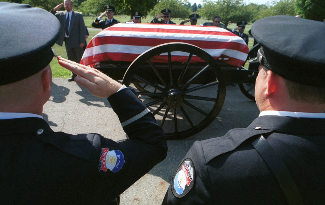 First Place, Student Photographer of the Year - David Distelhorst / Ohio UniversityPolice Officer Guy Grinstead (left) along with fellow officers from the Whitehall Police Department salute as the casket carrying slain Officer Terry L. McDowell moves through Forest Lawn Memorial Gardens to his final resting place, August 29, 2001.