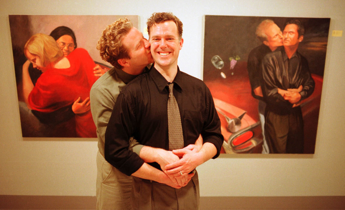 First Place, Student Photographer of the Year - David Distelhorst / Ohio UniversityArtist Jeff Stevenson (right)and his partner Ross Peplow share a moment at the Lindley Cultural Center gallery during a reception for the Ohio University graduate featured during Big Gay Love Week in Athens, February 14, 2001.