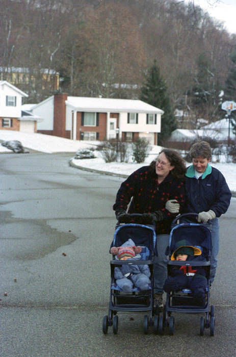 First Place, Student Photographer of the Year - David Distelhorst / Ohio UniversityThe definition of the American Family is constantly changing. Results of the 2000 census showed that homosexual couples live in nearly every county in the United States. These couples are raising families despite laws that make it difficult to do so. This is the story of two mothers. Their situation is not uncommon and their type of family is not difficult to find. Wendy Nilsen (left) and her partner Judy Miller take their children, Ben and Amy, for a walk in their hometown of Athens. The two have been together for seven years.