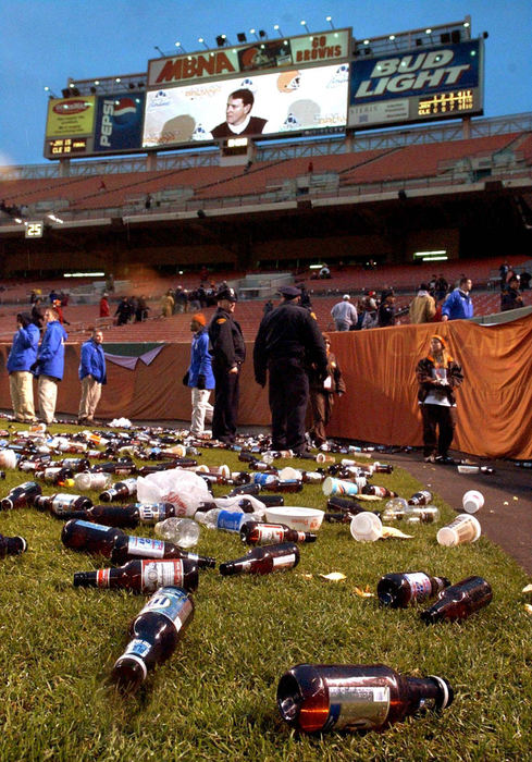 First Place, Sports Picture Story - Scott Heckel / The RepositoryBrowns head coach Butch Davis post game press conference is shown on the stadium's scoreboard as plastic bottles, cups and dog bowls litter the field following the conclusion of the game with the Jacksonville. Cleveland owner Al Learner said, "So we didn't have the most stable people in the stands". Team president added, "I like that the fans care about this team and care about this game". Both apologized a day later.