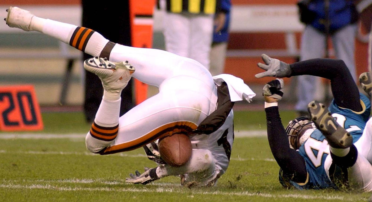 First Place, Sports Picture Story - Scott Heckel / The RepositoryCleveland's Quincy Morgan, left, bounces up off the turf after catching a pass from quarterback Tim Couch for an apparent first down as the Browns were  driving late in the fourth quarter of their game with the Jacksonville Sunday Dec. 16, 2001. Providing coverage on the play is the Jaguars James Boyd. The catch was reviewed and reversed causing fans to throw bottles of beer onto the field and play being haulted. 