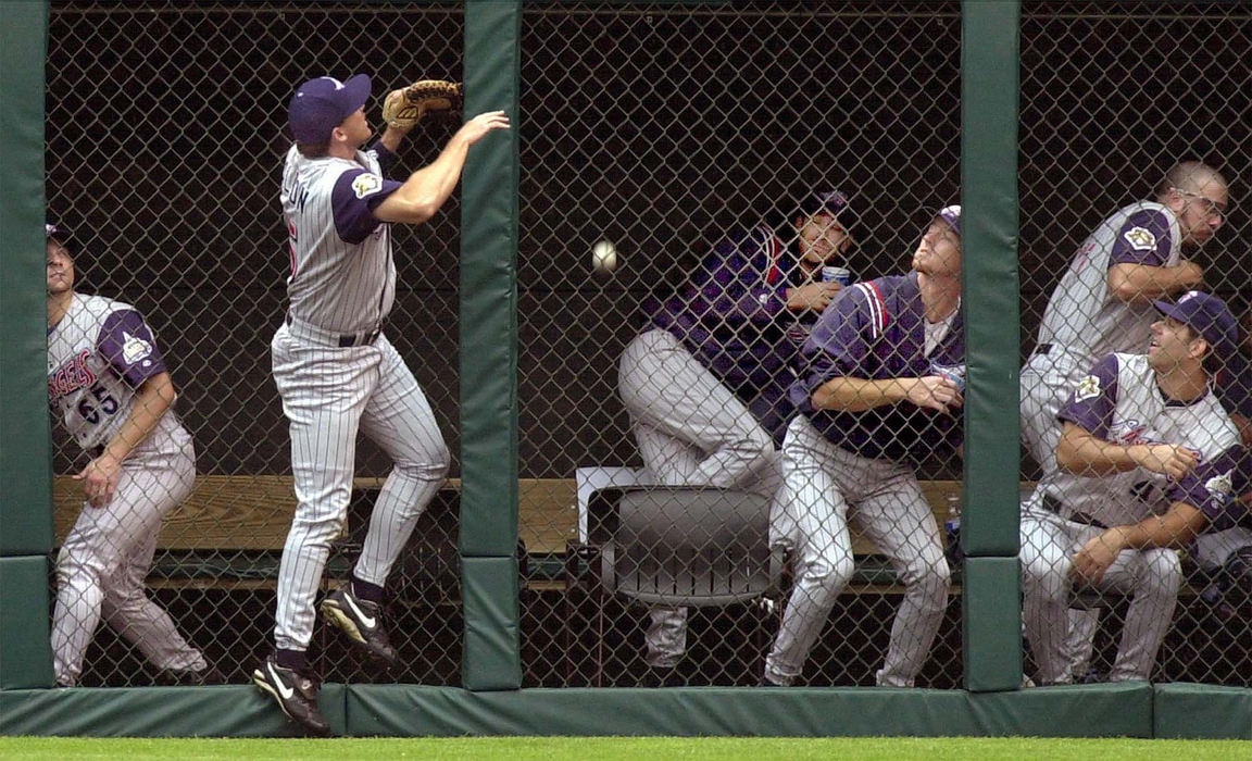 Second Place, Sports Picture Story - Chuck Crow / The Plain DealerThe Indians bats start to wake up.  The California Angels bullpen scatters as Cleveland Indian Juan Gonzalez's  first inning homer lands in the bullpen.  Angels right fielder Tim Salman watches as ball land over the fence.  The bullpen might not have awake yet as this was the early Sunday game. 