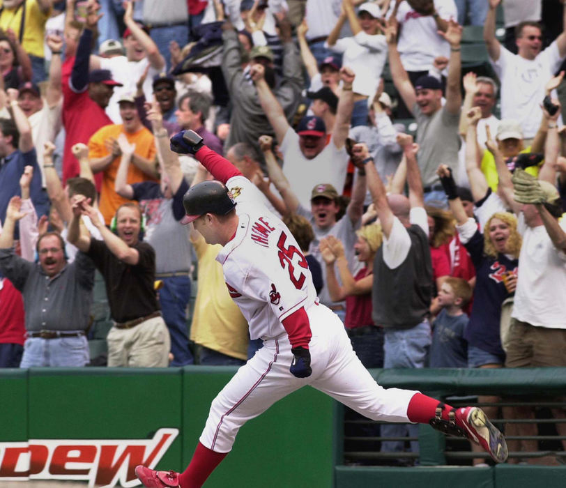 Second Place, Sports Picture Story - Chuck Crow / The Plain DealerAs Jim Thome heated up, so did the Indians. Here, Thome rounded 1st base after hitting a game winning 2-run homer to beat the Detroit Tigers.  Fans celebrated behind.