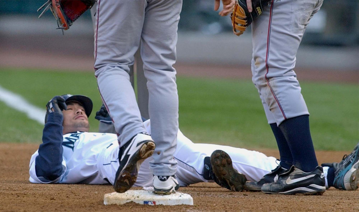 Second Place, Sports Picture Story - Chuck Crow / The Plain DealerIchiro Suzuki, right fielder for the Seattle Mariners, looks up at Cleveland Indians' Roberto Alomar (left) and Jim Thome after he was picked off first base in the third inning.  Cleveland won the first game in a best of 5 Divisional playoff series.  A key factor in the victory was keeping Suzuki, the leadoff hitter for the Mariners, off the bases.