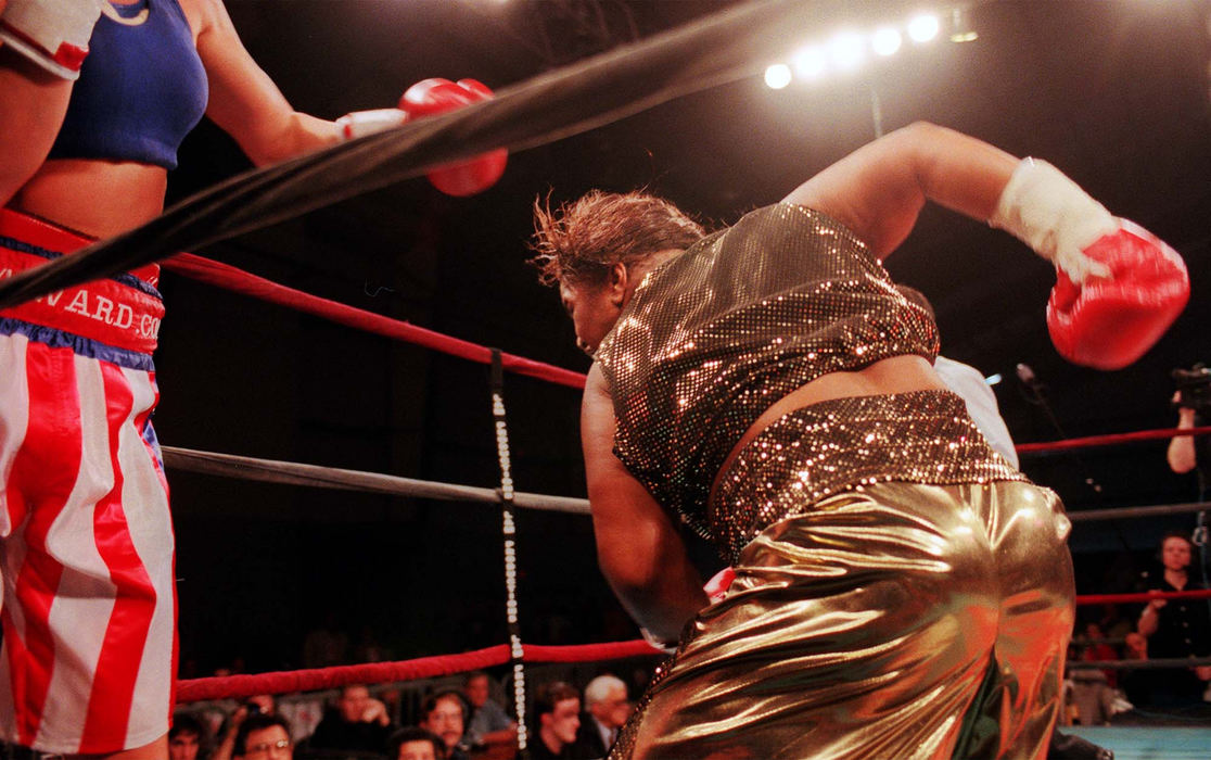 Third Place, Sports Picture Story - Gus Chan / The Plain DealerKisha Snow backs Vonda Ward up against the ropes while unleashing a flurry of punches in their fight Friday, February 2, 2000, in Columbus.