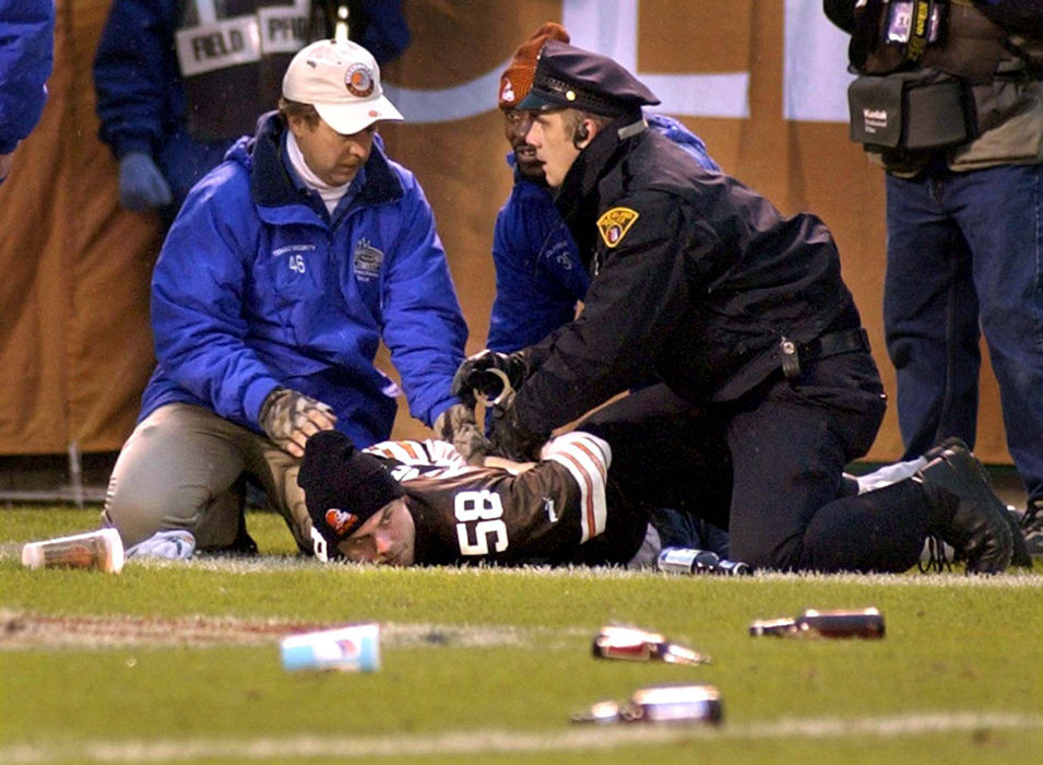 First Place, Sports Picture Story - Scott Heckel / The RepositoryA fan is placed under arrest and handcuffed by Cleveland police and stadium security personnel during the bottle throwing incident. It was one of several arrests following fan misconduct at the game in retaliation of an officials ruling.