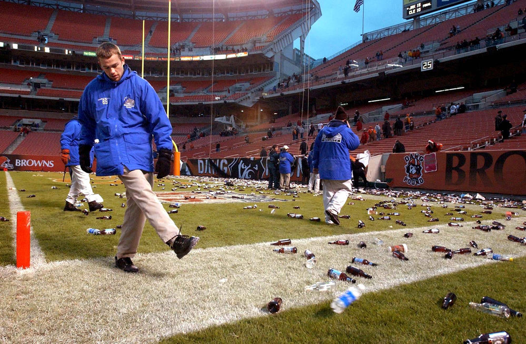 First Place, Sports Picture Story - Scott Heckel / The RepositoryA security guard at Cleveland Browns Stadium kicks a water bottle out of the end zone after fans in the Dawg Pount showered debris onto the field and play was haulted. A half hour later, the final 48 seconds of the game was played under orders from the commissioner of the NFL. 