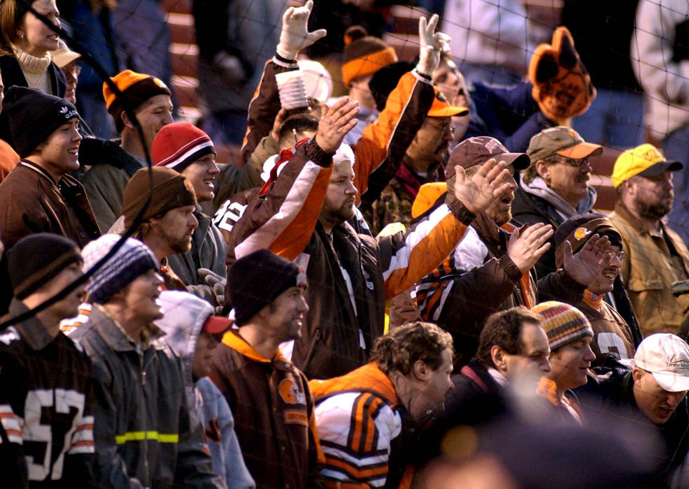 First Place, Sports Picture Story - Scott Heckel / The RepositoryCleveland Browns fans return to the stadium after hearing the final 48 seconds of the game would resume. This time  fans in the end zone are "restrained" from throwing additional bottles onto the field after a net, which normally keeps balls from entering the stands, is raised in front of the Dawg Pound.