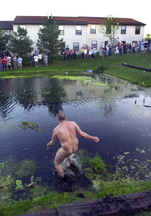 Second Place, Team Picture Story - Phil Masturzo / Akron Beacon JournalMuch to the amusement of fellow partygoers, a naked man wades into the water at the University Town homes in Kent. Drunken foolishness by daytime turned to rioting and burning cars by night. 