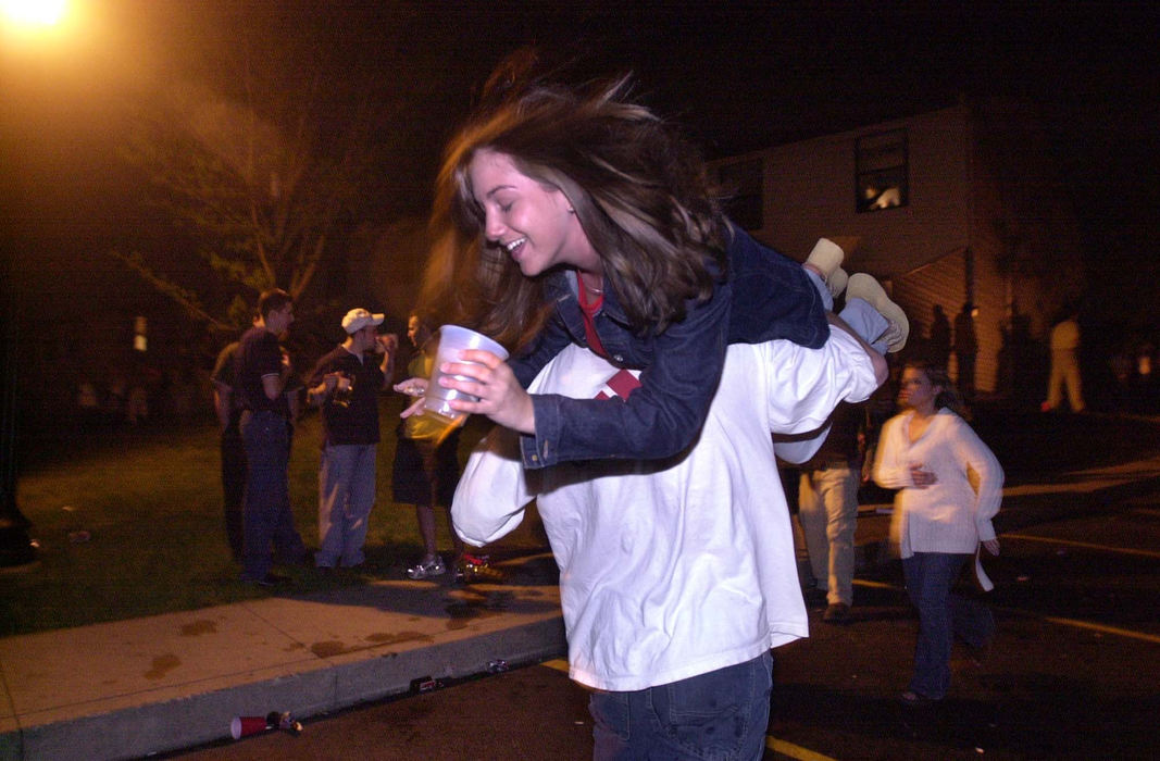 Second Place, Team Picture Story - Phil Masturzo / Akron Beacon Journal End of the semester celebrants wander from party to party as  Kent State University students get carried away with drinking during May Day festivities along Summit Street. 