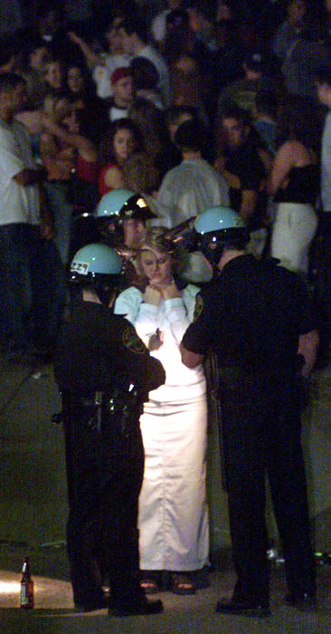 Second Place, Team Picture Story - Mike Cardew / Akron beacon JournalKent Police, looking for underage drinking, check the ID of a partygoer along University avenue in Kent.