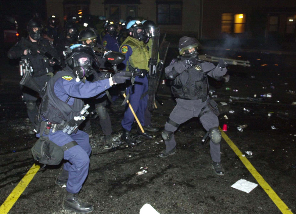 Second Place, Team Picture Story - Lew Stamp / Akron Beacon JournalPortage County Sheriffs deputies and Kent police using rubber projectiles and tear gas, clear the parking lot of partiers at University Town homes  off Summit Street near the Kent State University campus in Kent . The rioters set  several fires including an overturned automobile.