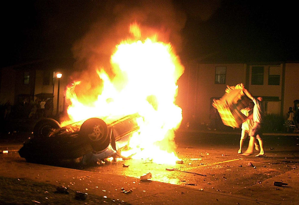 Second Place, Team Picture Story - Phil Masturzo / Akron Beacon JournalKent State University students fuel burning car fire with sofa chair in University Townhomes off  Summit Street in Kent. 