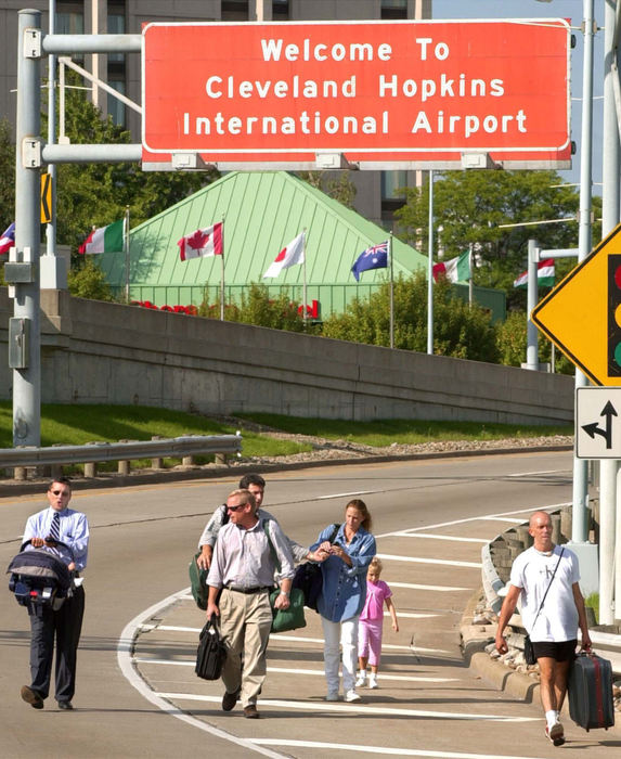 Third Place, Team Picture Story - John Kuntz / The Plain DealerAirline travelers are told to leave the Cleveland Hopkins Airport with luggage in hand after the airport closed and all flights were ordered by the FAA to land at the nearest airport, Sept.11, 2001 after terrorist attacks in New York and at the Pentagon. 