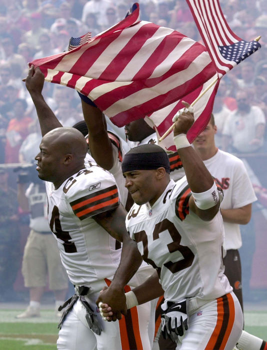 Third Place, Team Picture Story - David I. Andersen / The Plain DealerReflecting the emotions of a flag-waving crowd, the Browns' starting defensive backfield - Daylon McCutcheon (33), Corey Fuller (24), Percy Ellsworth and Earl Little - emerges as a unit during introductions for the Sept. 23 game against the Detroit Lions.  It was the first NFL game since the Sept. 11 attacks.