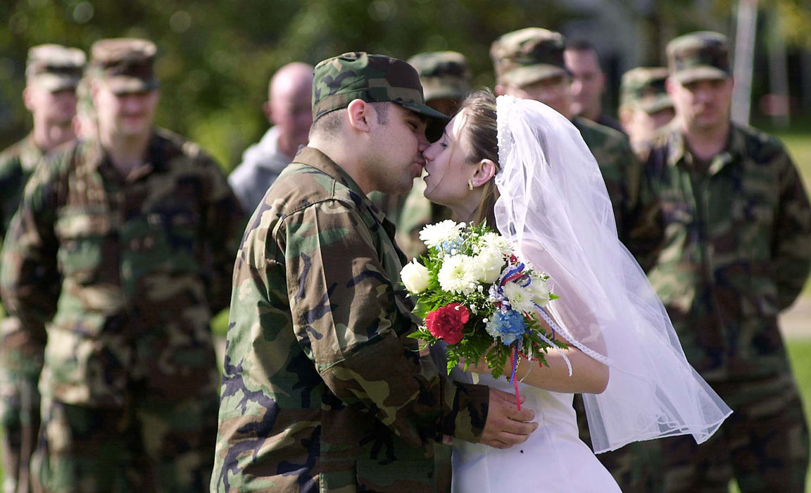 First Place, War on Terror - Scott MacDonald / Zanesville Times RecorderDavid Borges kisses Angela Dalessio after she became Mrs. Borges during a double wedding at the U.S. Army Reserve Training Center in Zanesville. Two couples quickly arranged weddings after the grooms were called for duty in the wake of the terrorist attacks of Sept. 11.