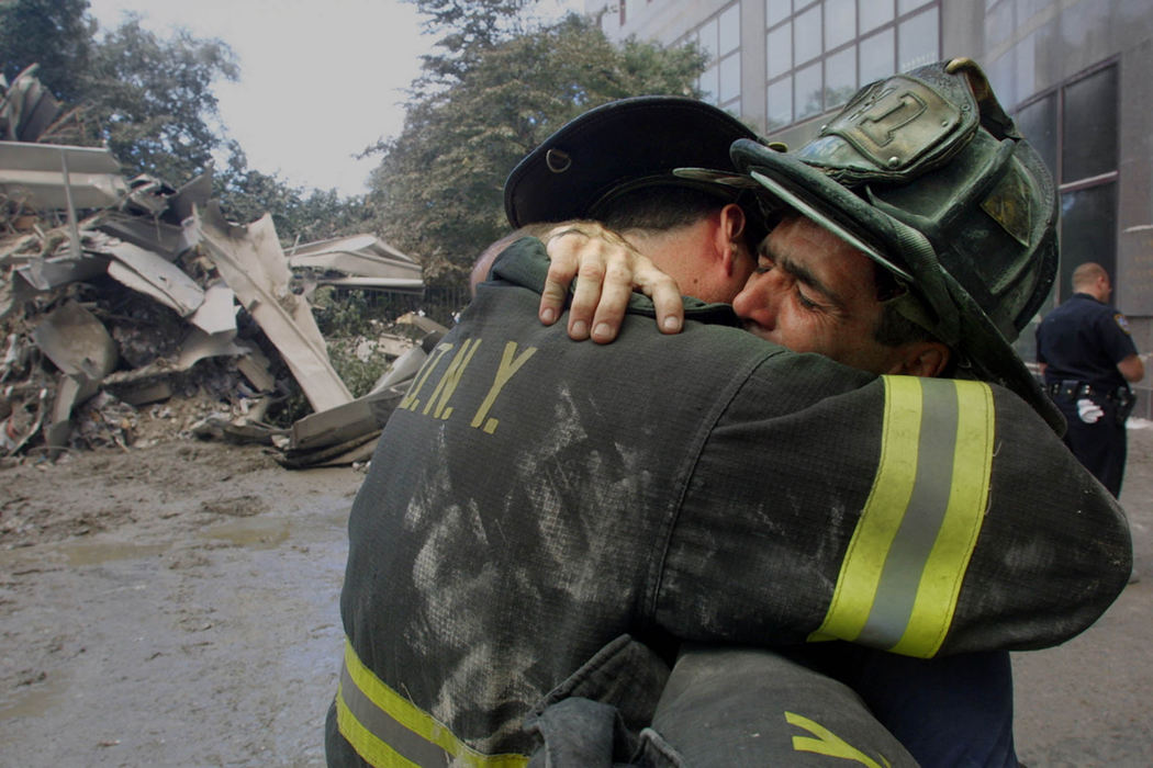 Second Place, War on Terror - Neal C. Lauron / The Columbus DispatchFire fighter Michael Smith, left, consoles his friend Gib Craig who lost seven members of his Special Operations Command Squad 41 after the first tower of the World Trade Center collapsed in the September 11 terrorist attacks on the United States. Company wide 70 Special Operations Command members of the New York Fire Department are missing.