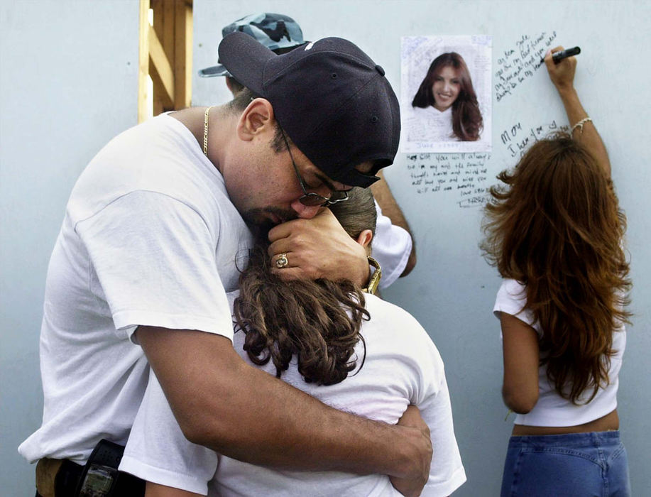 Award of Excellence, War on Terror - Karen Schiely / Akron Beacon JournalEdwin Rivera hugs his cousin Jennifer Hernandez, 12, whose mother Rosa  Julia Gonzalez died in the World Trade Center attack. Family members of Gonzalez put her picture on a memorial wall during a service for victims' families held at  Liberty Park in Jersey City, New Jersey. 