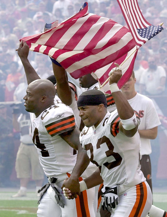 Award of Excellence, War on Terror - David I. Andersen / The Plain DealerReflecting the emotions of a flag-waving crowd, the Cleveland Browns' starting defensive backfield runs onto the field during introductions before the first game played after the attack on the World Trade Center.