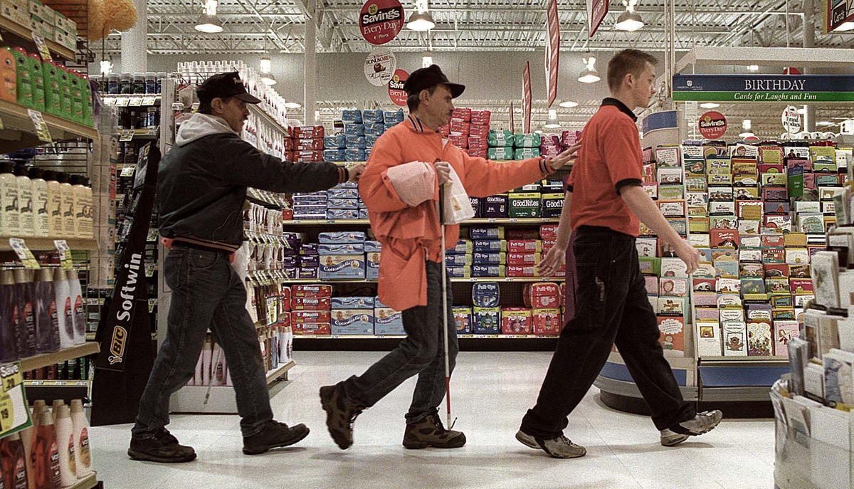 Award of Excellence, Assigned Feature - Dale Omori / The Plain DealerBlind twins Bruce and Bryan Tegowski follow Tops employee Pete Cieckiewicz through the store Jan 23, 2002, Parma.