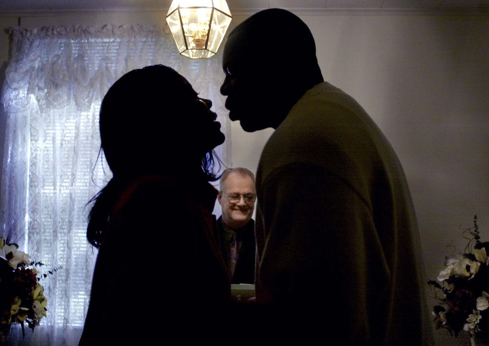 Second Place, Enterprise Feature - Dipti Vaidya / The Columbus DispatchDelvin Ballantine kisses the bride Charlene Whitby at their Valentine's Day "walk-in" wedding at the Columbus Wedding Services Chapel. Pastor John Butler performed about 40 weddings on February 14, a "walk-ins" only day at the chapel.    