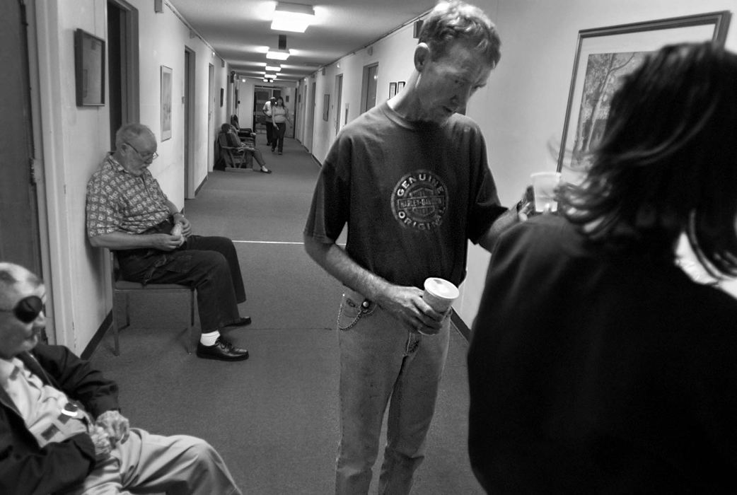 Third Place, Feature Picture Story - Greg Ruffing / Kent State UniversityMedication time at the care center: a nurse gives Bryan his daily dose of medication in hopes of controlling the often intrusive and disruptive symptoms of his condition.