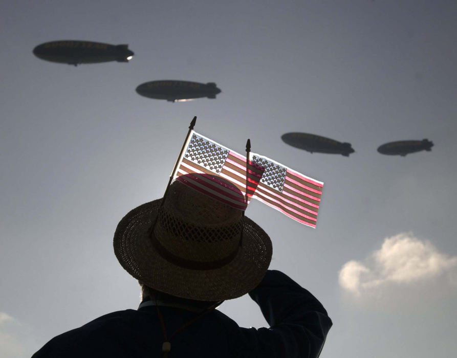 Award of Excellence, General News - Bill Kennedy / The Plain DealerDennis Bowsher of Tallmadge, a former Goodyear Aerospace employee, watches the four Goodyear blimps circle Wingfoot Lake Park in Suffield Township, September 5, 2002.