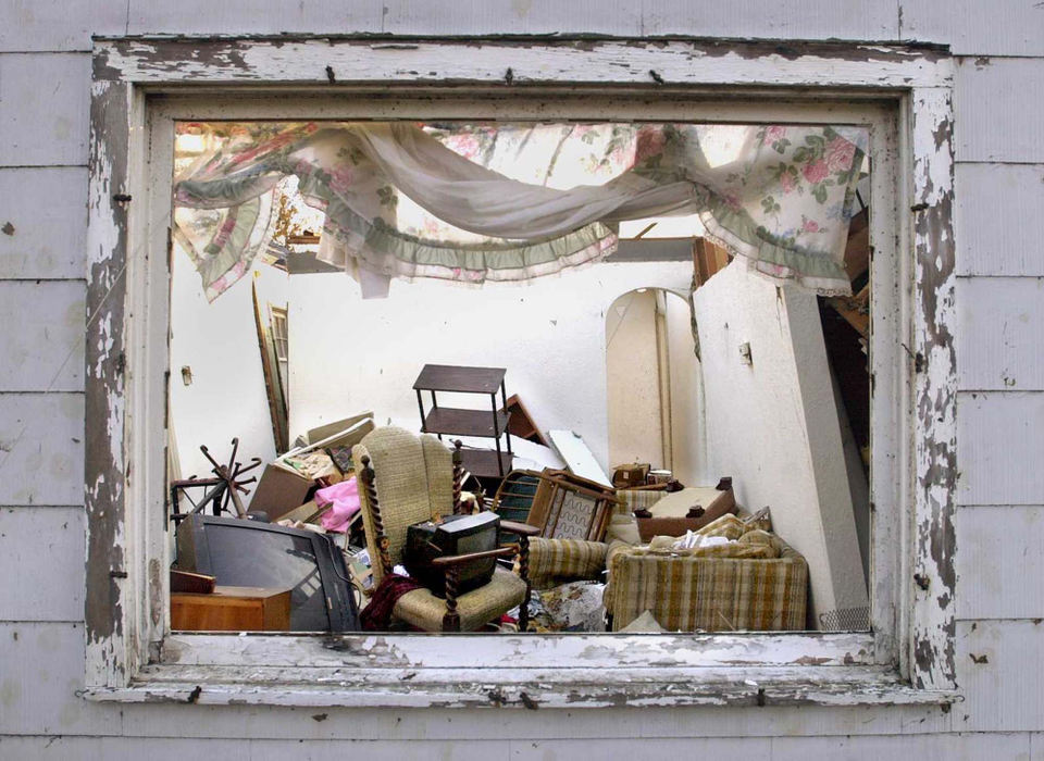 Second Place, News Picture Story - Allan Detrich / The BladeA framed view of the inside of the Marveleen Weenger home on Cedar St. reveals that the chair where the TV sits, is where Marveleen, 78, was sitting when a car, thrown by a tornado, slammed into her home. Knocking her to the ground and across the room. Putting the TV in the chair where she was sitting.