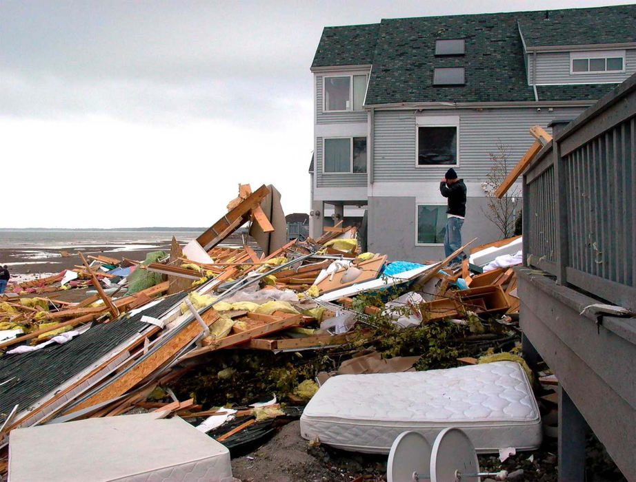 Second Place, News Picture Story - Allan Detrich / The BladeDave Massey takes photos of his condo that was blown into Lake Erie by the November 10th tornado, which hit Port Clinton.