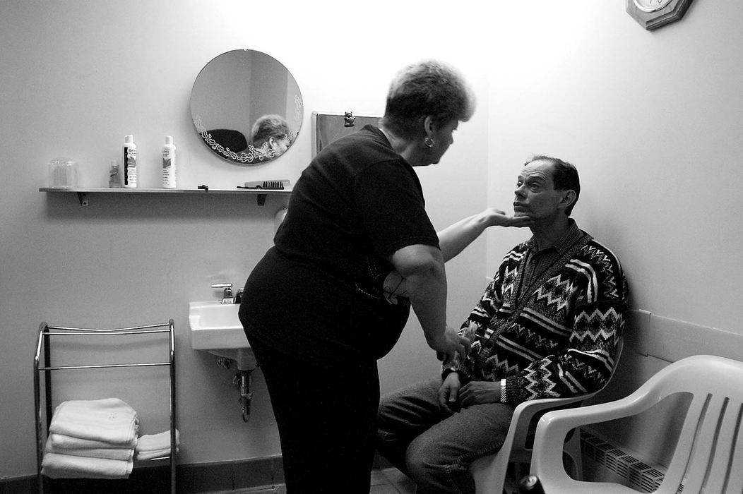 Third Place, News Picture Story - Monique Ganucheau / Medina GazettePhyllis Brown, aid in charge of the first floor men's wing, checks resident John Aucker's face to make sure he didn't miss a spot when shaving.