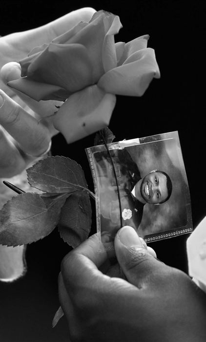 First Place, News Picture Story - Ed Suba, Jr. / Akron Beacon JournalA photograph of slain Massillon police officer Eric Taylor is held by a member of the Massillon police force during his memorial service at Mt. Peace Cemetery in Akron. 