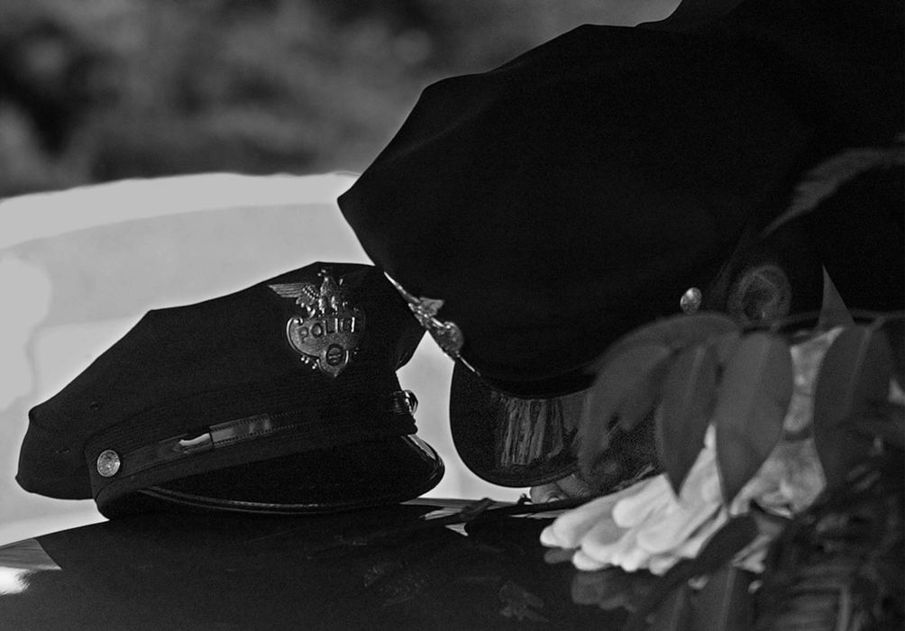 First Place, News Picture Story - Ed Suba, Jr. / Akron Beacon JournalA Massillon police officer kisses the casket of slain Massillon police officer Eric Taylor while paying his last respect after a memorial service at Mt. Peace Cemetery in Akron.