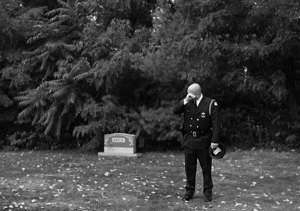 First Place, News Picture Story - Ed Suba, Jr. / Akron Beacon JournalA Massillon police officer wipes tears from his eyes after paying his last respect to slain Massillon police officer Eric Taylor after a memorial service at Mt. Peace Cemetery in Akron.