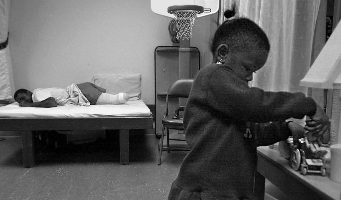 First Place, Ohio Understanding Award - Ed Suba, Jr. / Akron Beacon JournalWhile Leroy rests during a break in his physical therapy at Akron Children's Hospital, his sister, Keyaira, plays with a doll and a toy wheelchair.