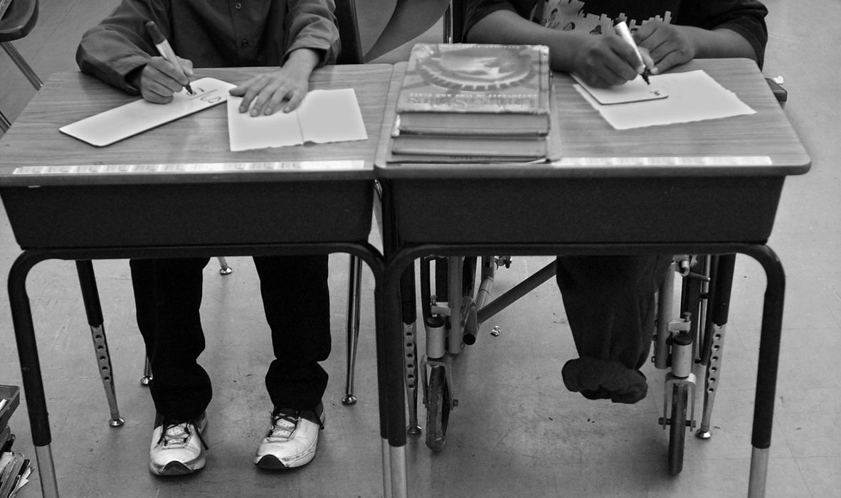 First Place, Ohio Understanding Award - Ed Suba, Jr. / Akron Beacon JournalLeroy Sutton (r) works on an assignment in Tracey Cason's fifth grade classroom during his first day of school at Anne T. Case Elementary school in Akron.  It is the only school in the district that was wheel-chair accessable. It is Leroy's third school in less than a year.