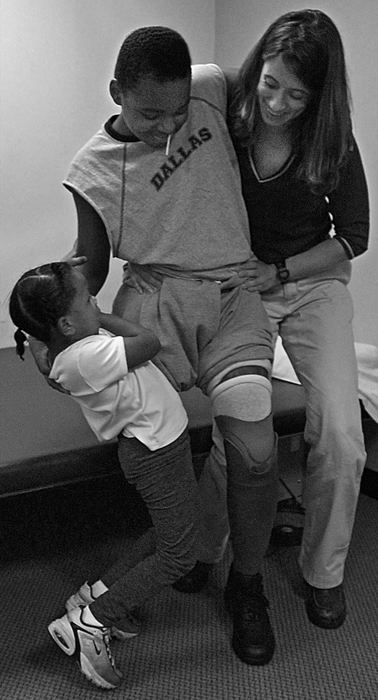 First Place, Ohio Understanding Award - Ed Suba, Jr. / Akron Beacon JournalWith some shaky but determined help from his sister, Keyaira and his physical therapist, Jody Kreitburg, Leroy Sutton attempts to stand on the first of his artificial legs during a therapy session at Akron's Childrens Hospital.