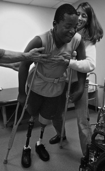 First Place, Ohio Understanding Award - Ed Suba, Jr. / Akron Beacon JournalAkron Children's Hospital physical therapist Jody Kreitzburg  and an associate grab a falling Leroy Sutton as he tries to stand for the first time on both his prosthetic legs. 