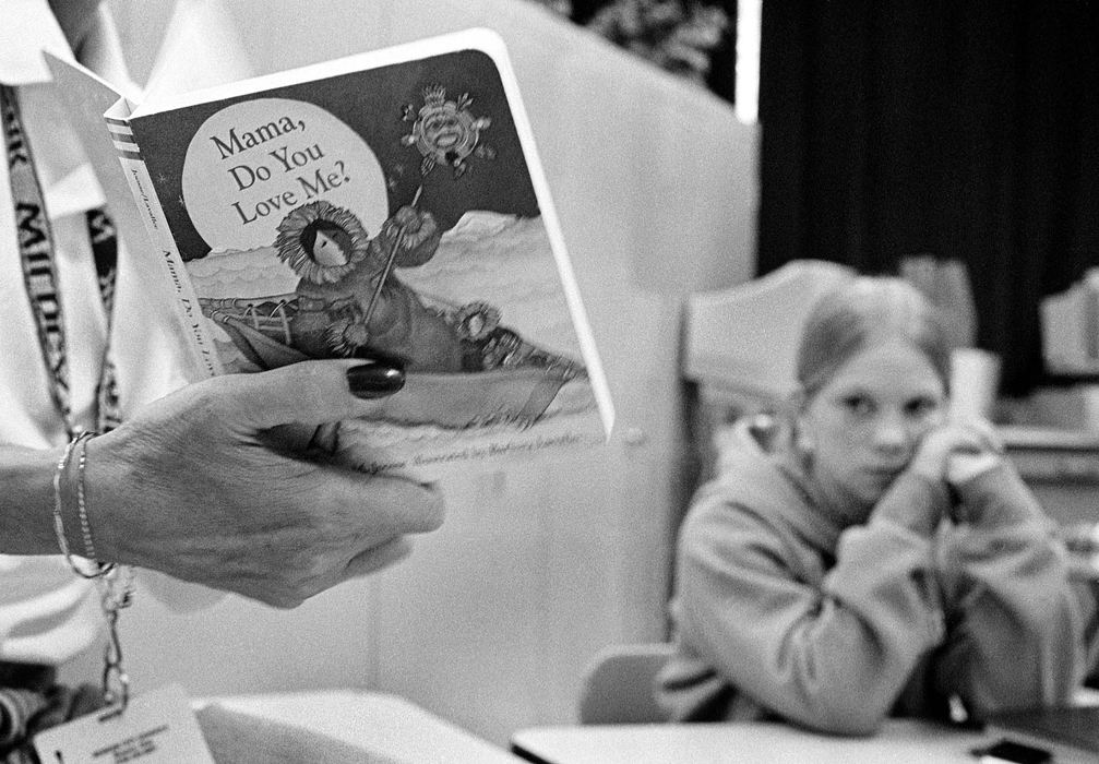 Second Place, Ohio Understanding Award - James M. Patterson / Ohio UniversityJanet McIntyre listens as GRADS teacher Linda James reads a childrens book. Students like Janet are urged to read to their children and keep a record of when, and what they read.