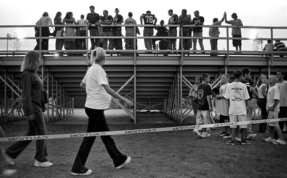 Second Place, Ohio Understanding Award - James M. Patterson / Ohio UniversityAlissa and friend Tiffany walk behind the student section of stands at a Newark High School football game. Alissa is one of the few GRADS students at the school with a supportive core of family and friends.