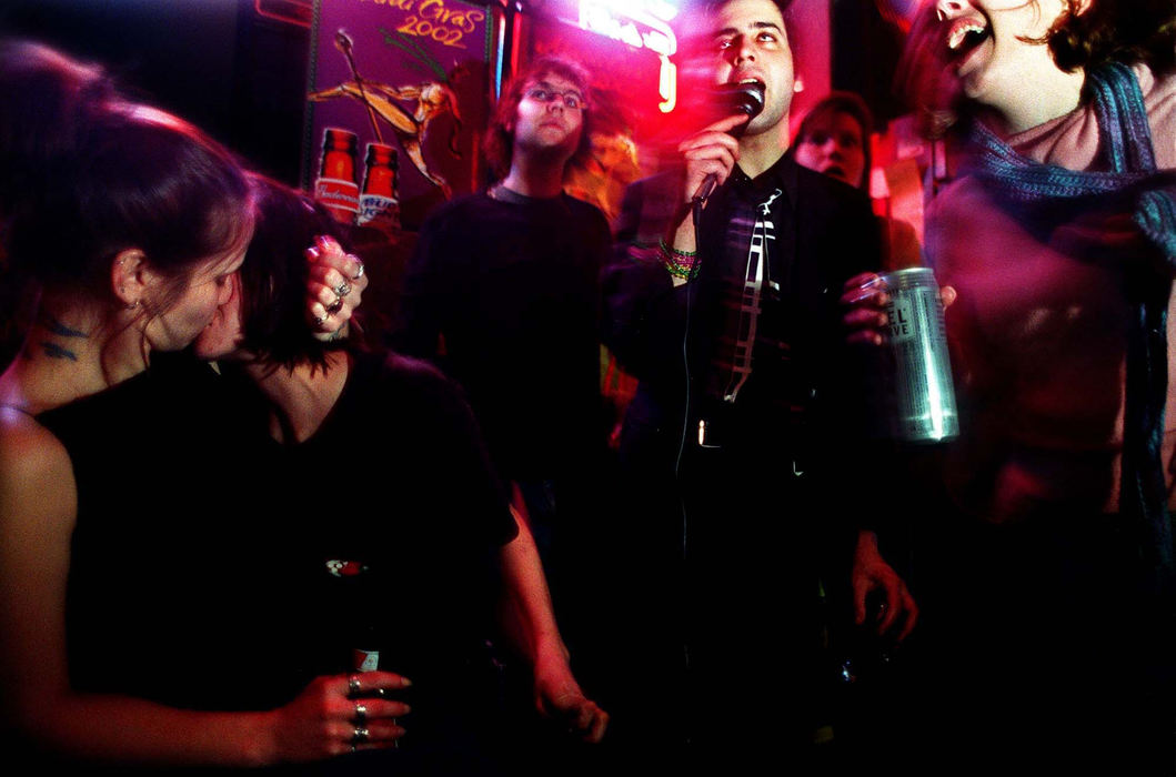 Third Place, Ohio Understanding Award - Steven M. Herppich / Cincinnati EnquirerCamille Wagner kisses Michelle Stock, 26, on her 21st birthday while Mark Dunbar, 24, of Northside, sings a 'Go-Go's' song during karaoke night at Shirley's Bar in Clifton, February 3, 2002. 