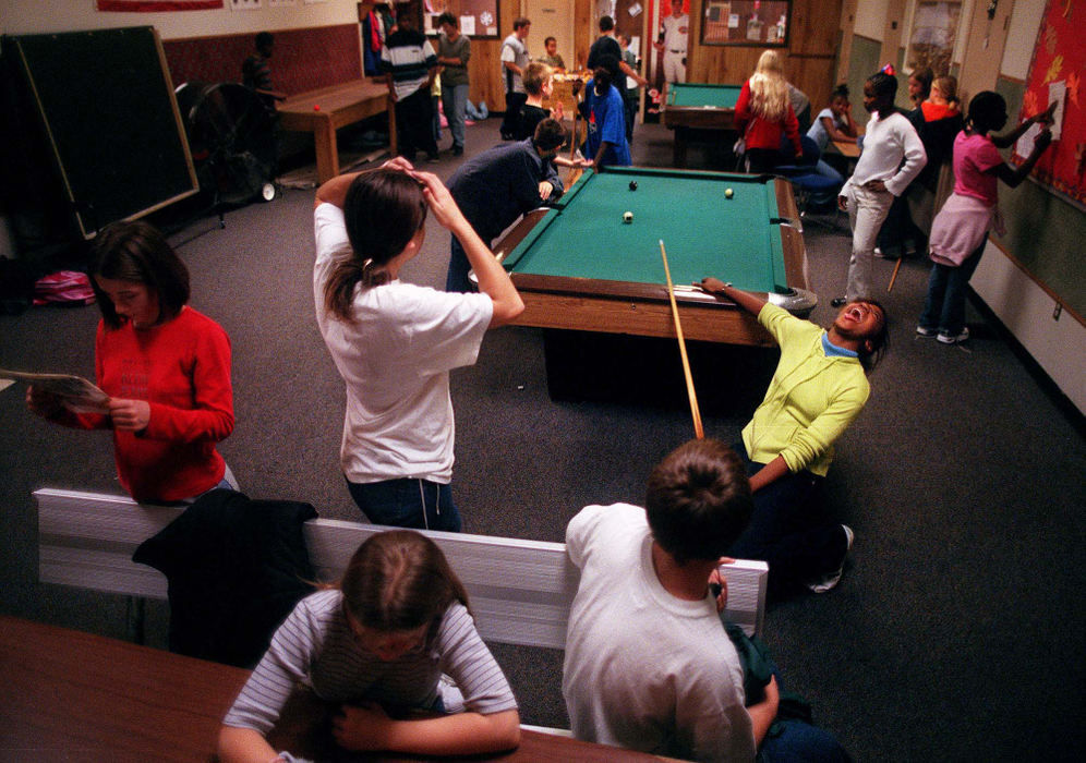 Third Place, Ohio Understanding Award - Steven M. Herppich / Cincinnati EnquirerAshleigh DuBois (right) jokes around with Amanda Williams (center) in the game room of the ESPY Boys & Girls Club on Glenway Ave. in Lower Price Hill, November 13, 2002. The club, smallest of the five in greater Cincinnati, has 300 members and any day of the week 90 children will show up for friendship and an evening meal.