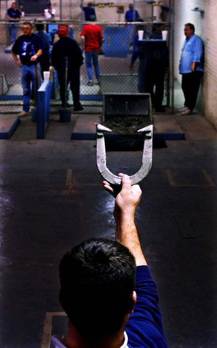 Third Place, Ohio Understanding Award - Steven M. Herppich / Cincinnati EnquirerTim King, 29, of Milford, sizes up his first of two horseshoes during a game on league night at the OK Horseshoe Club in Queensgate, December 10, 2002. 