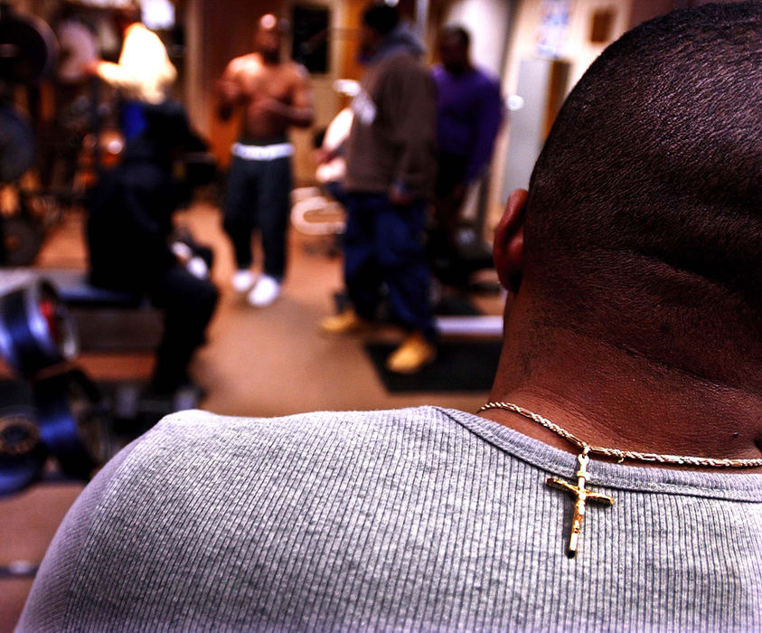 Third Place, Ohio Understanding Award - Steven M. Herppich / Cincinnati EnquirerAaron Jones, 27, of Corryville, wears a crucifix around his neck during a work out and bible study session at the Lord's Gym on Liberty and Walnut Ave., April 4, 2002. 