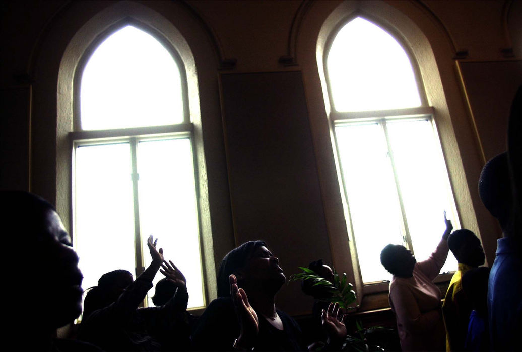 Third Place, Photographer of the Year - Dale Omori / The Plain DealerTangela Adams, of Cleveland, worships in a packed house at the Mega Church on Palm Sunday, Mar. 24, 2002, on Cleveland's West Side. 