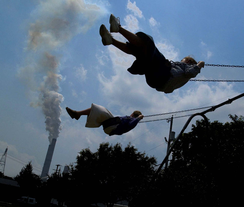 Award of Excellence, Photographer of the Year - Amy Sancetta / Associated PressUnder the ever-present spector of the American Electric Power Company's Gen. James M. Gavin Plant, two girls swing in the town park in Cheshire. The town and it's memories will all soon vanish as the problem polluter is in the process of buying up the entire community, and Cheshire will cease to exist. 