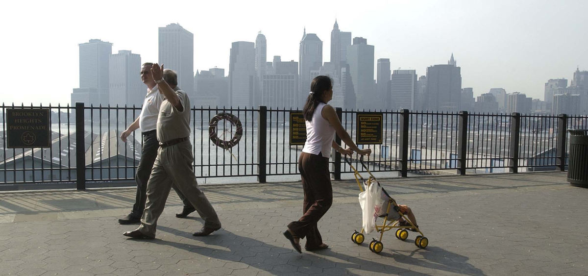 Award of Excellence, Photographer of the Year - Amy Sancetta / Associated PressAgainst the skyline of lower Manhattan, where the World Trade Center towers once stood, people stroll the Brooklyn promenade, Aug. 5, 2002. The small wreath hanging on fence is in remembrance of the Sept. 11, 2001 attacks.