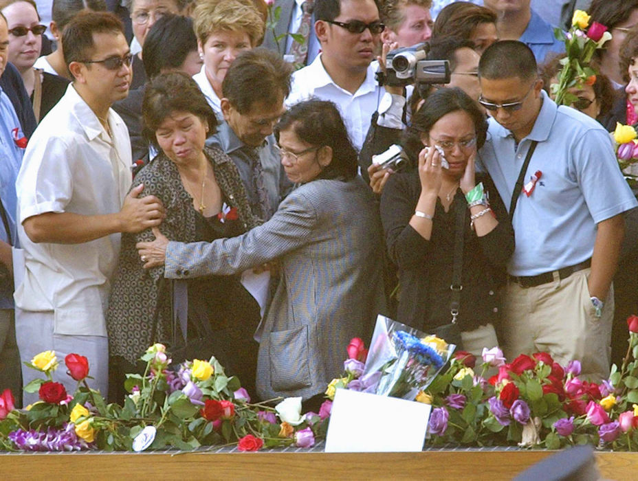 Award of Excellence, Photographer of the Year - Amy Sancetta / Associated PressIn the footprint of the fallen towers, mourners of victims of the attack on the World Trade Center leave flowers and remembrances as they honor their loved ones at a ceremony marking the one year anniversary of the attacks at ground zero in New York on Sept. 11, 2002. 